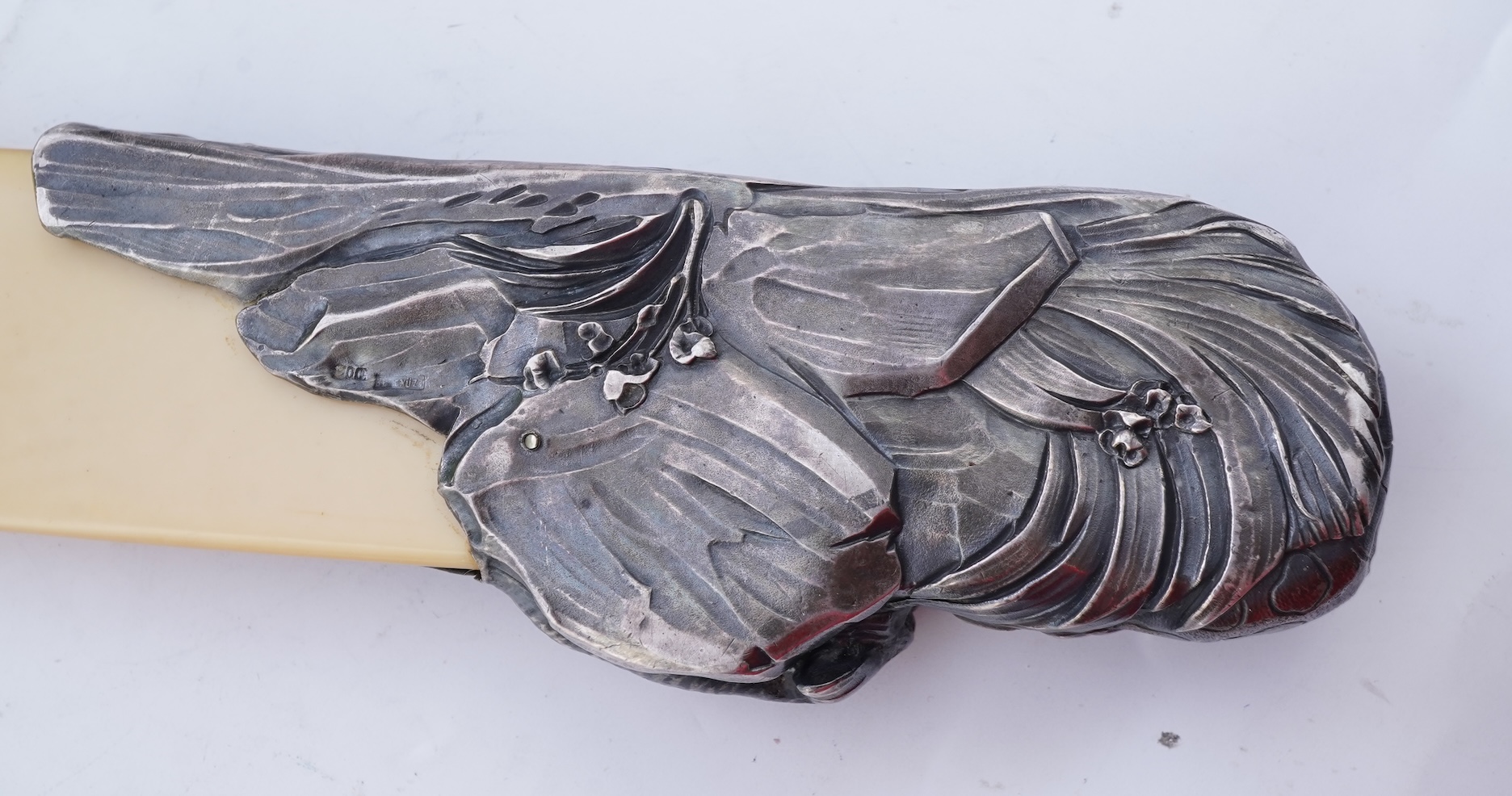 Two paper knives and a hair ornament, early 20th century